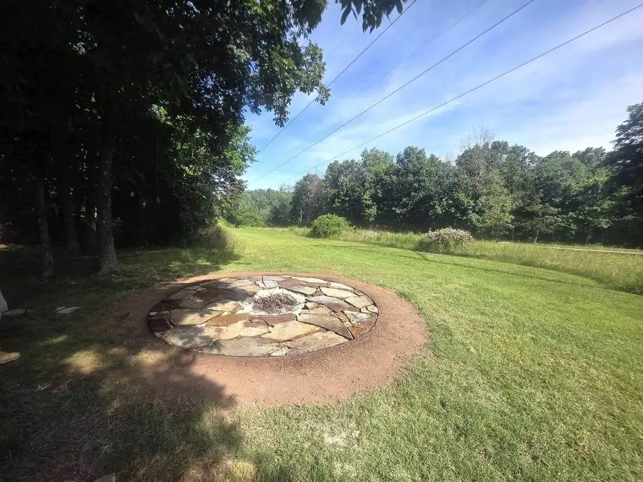 Fire pit and patio in an open lawn