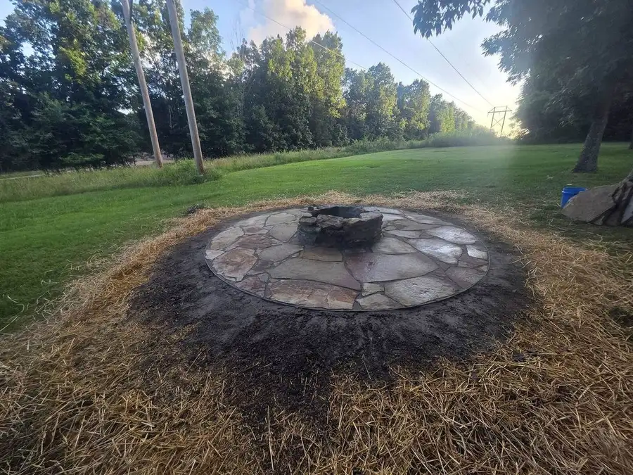 Flagstone fire pit with straw over fresh seed