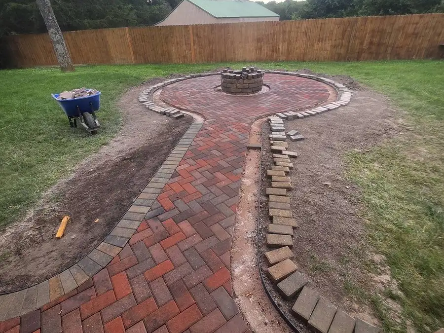 Herringbone brick walkway with a soldier-course edge running to a patio