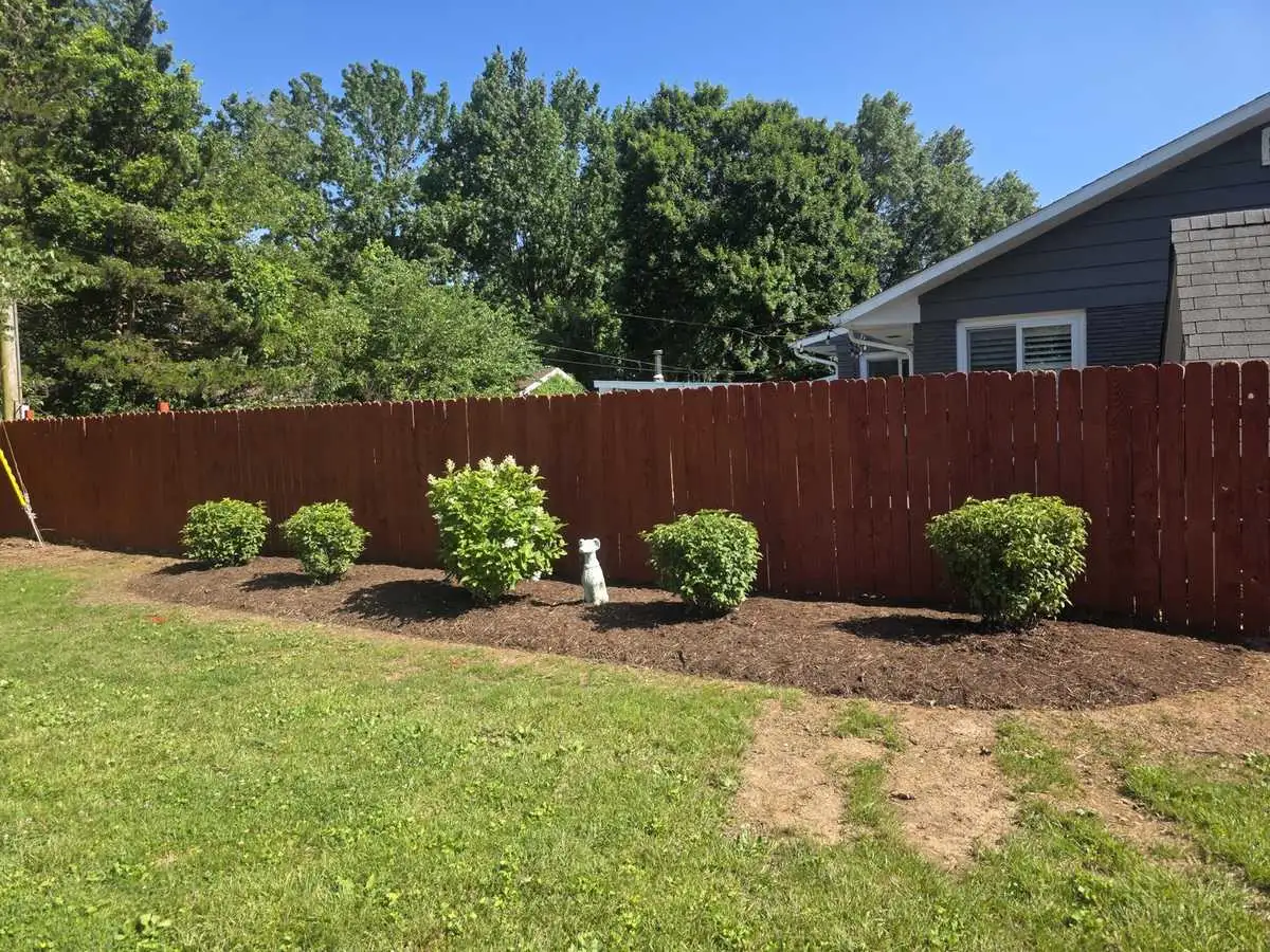 Maintained mulch beds along a fence