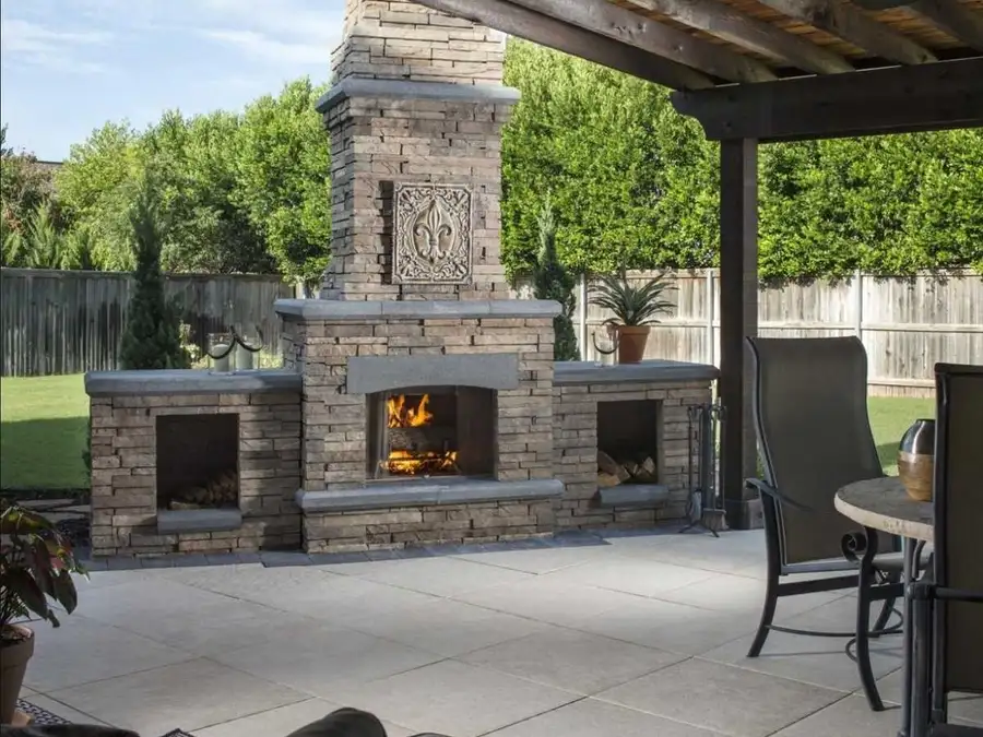 Covered patio with a stone outdoor fireplace