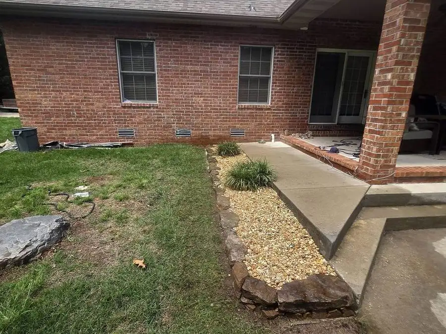 Stone border and mulch bed wrapping the edge of a patio